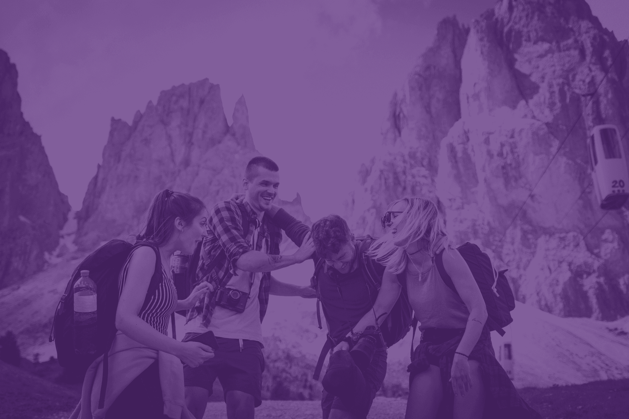 A purple overlayed photo of four friends laughing while hiking in front of some rocky cliffs